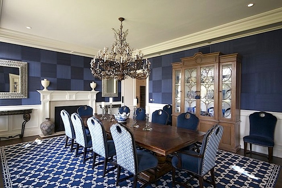 Idee per una grande sala da pranzo classica chiusa con pareti blu, parquet scuro, camino classico e cornice del camino in pietra