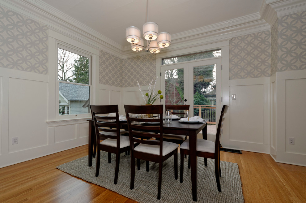Photo of a large classic open plan dining room in Portland with white walls and medium hardwood flooring.