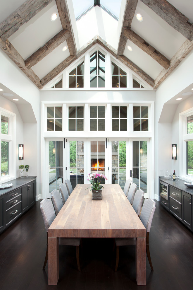 Example of a mid-sized mountain style dark wood floor enclosed dining room design in Minneapolis with white walls