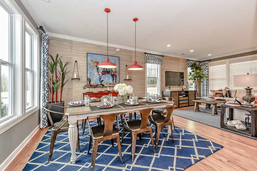 Photo of a small farmhouse open plan dining room in Charlotte with multi-coloured walls, light hardwood flooring and no fireplace.