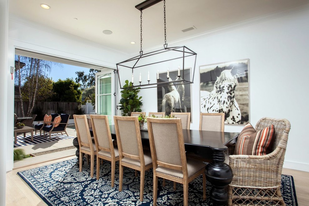 Example of a classic light wood floor dining room design in Orange County with white walls and no fireplace