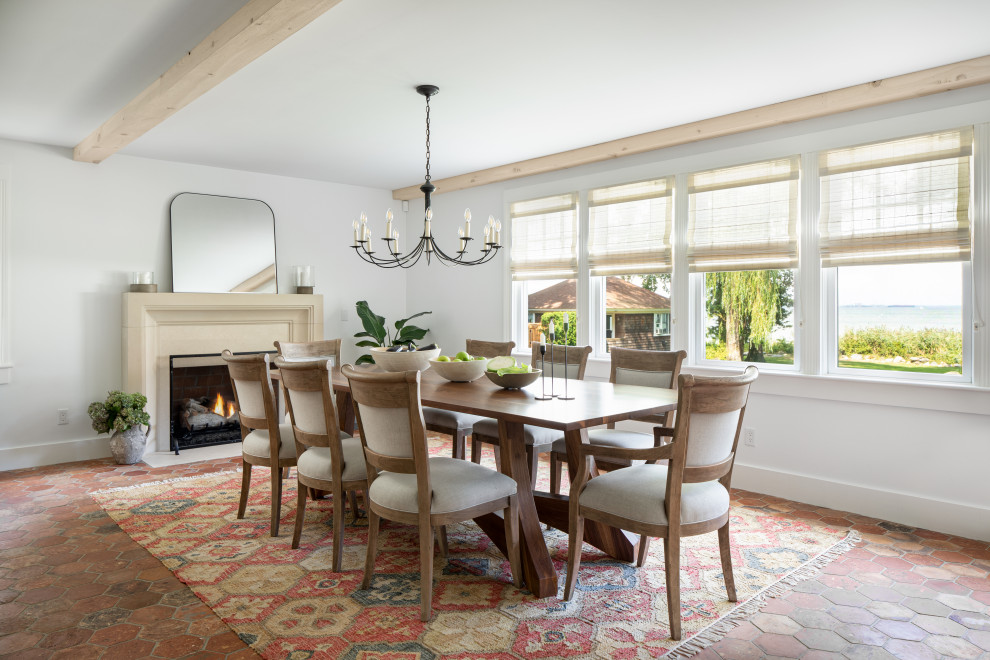 Photo of a coastal dining room in Providence with white walls, red floors and exposed beams.