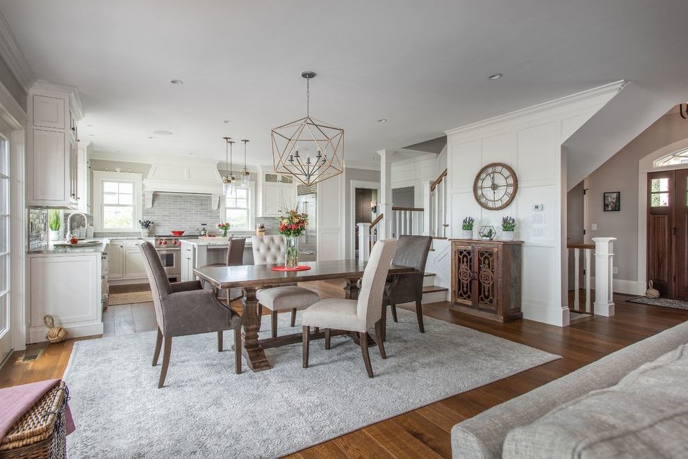 Design ideas for a large traditional open plan dining room in Boston with white walls, medium hardwood flooring and brown floors.