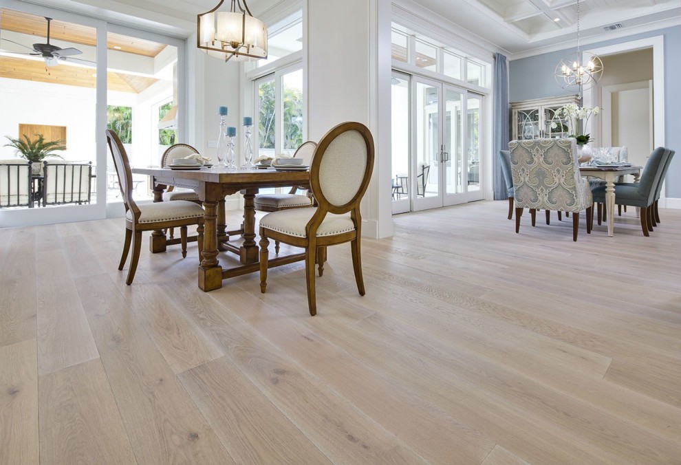 This is an example of a large contemporary kitchen/dining room in Orange County with white walls, light hardwood flooring, no fireplace and beige floors.
