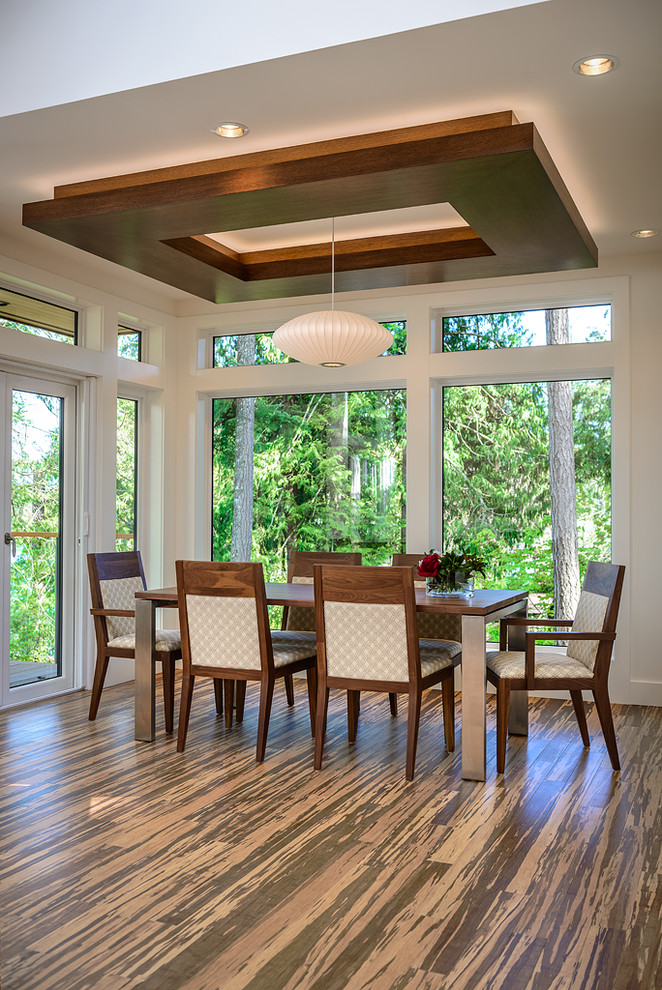Contemporary dining room in Vancouver with medium hardwood flooring.