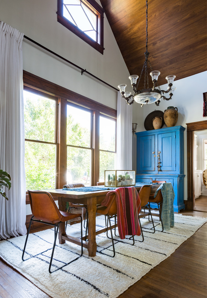 Large southwest dark wood floor and brown floor enclosed dining room photo in Houston with white walls