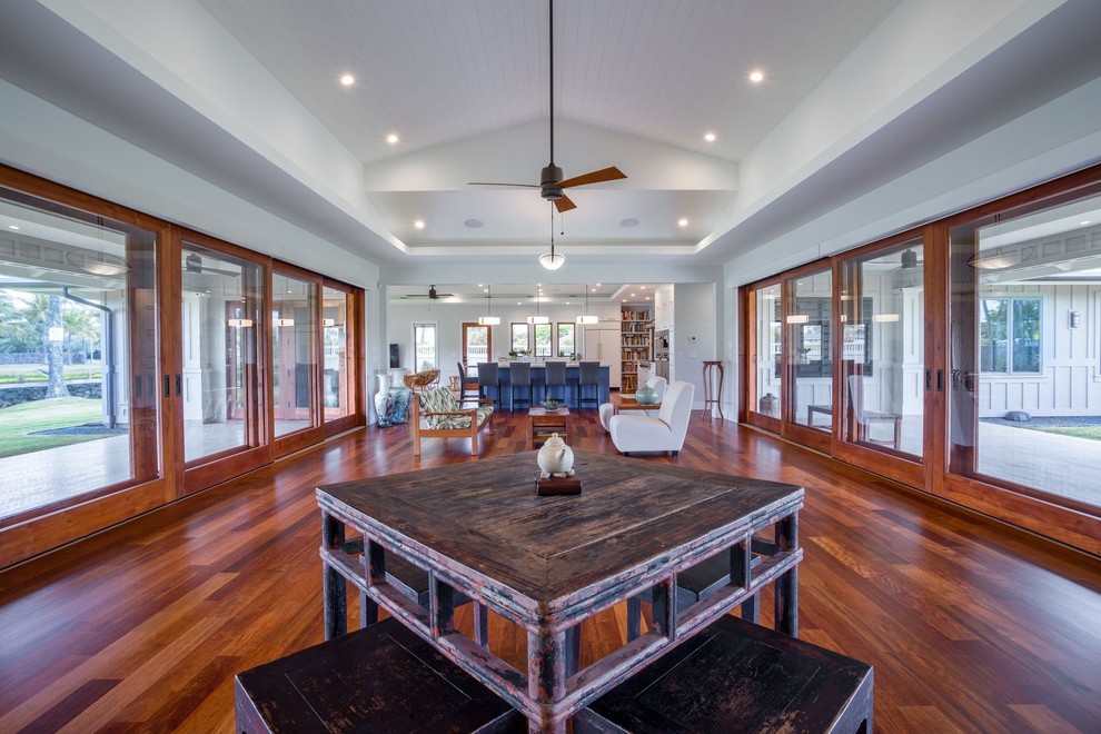 Medium sized traditional open plan dining room in Hawaii with white walls, dark hardwood flooring and brown floors.
