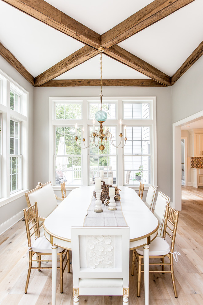 Coastal dining room in Philadelphia with light hardwood flooring, grey walls, no fireplace and beige floors.