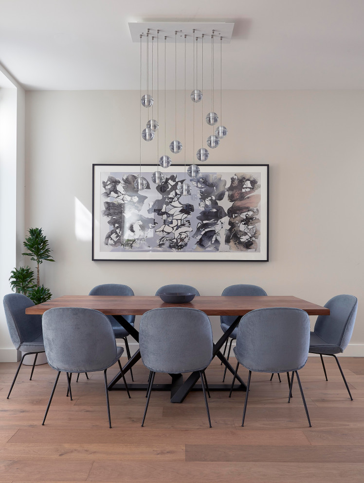 Photo of a large contemporary dining room in San Francisco with beige walls and brown floors.