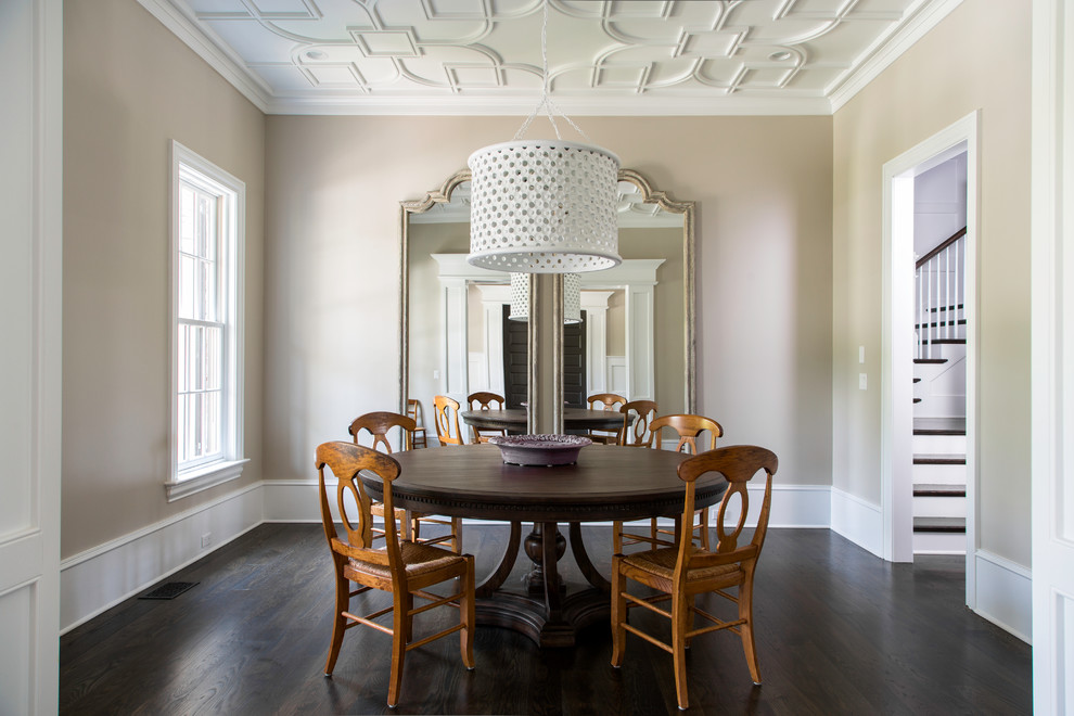 Example of a classic dark wood floor enclosed dining room design in Charleston with beige walls