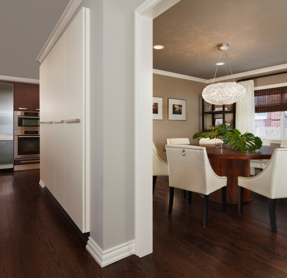Example of a mid-sized classic medium tone wood floor and brown floor enclosed dining room design in Detroit with beige walls