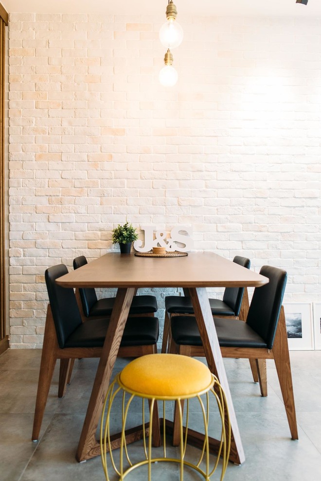 This is an example of a medium sized scandinavian dining room in Singapore with white walls and ceramic flooring.