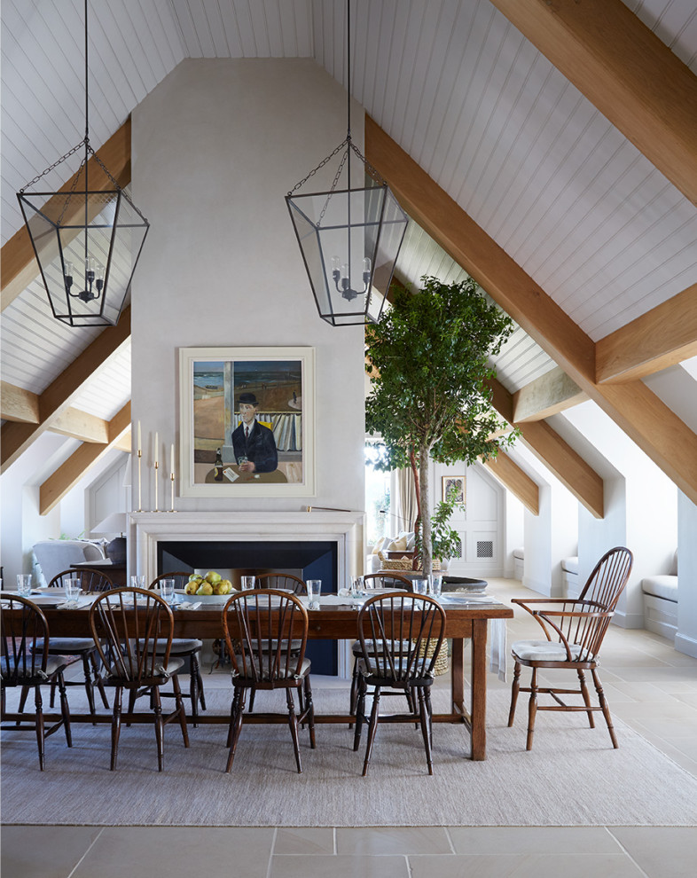 Design ideas for a large traditional open plan dining room in Oxfordshire with white walls, porcelain flooring, a standard fireplace, a metal fireplace surround, grey floors and a wood ceiling.