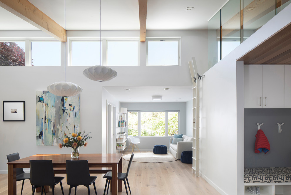 Example of a trendy light wood floor and beige floor dining room design in San Francisco with white walls