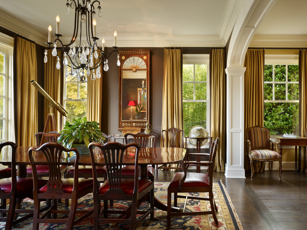 This is an example of a traditional dining room in Seattle with brown walls and dark hardwood flooring.