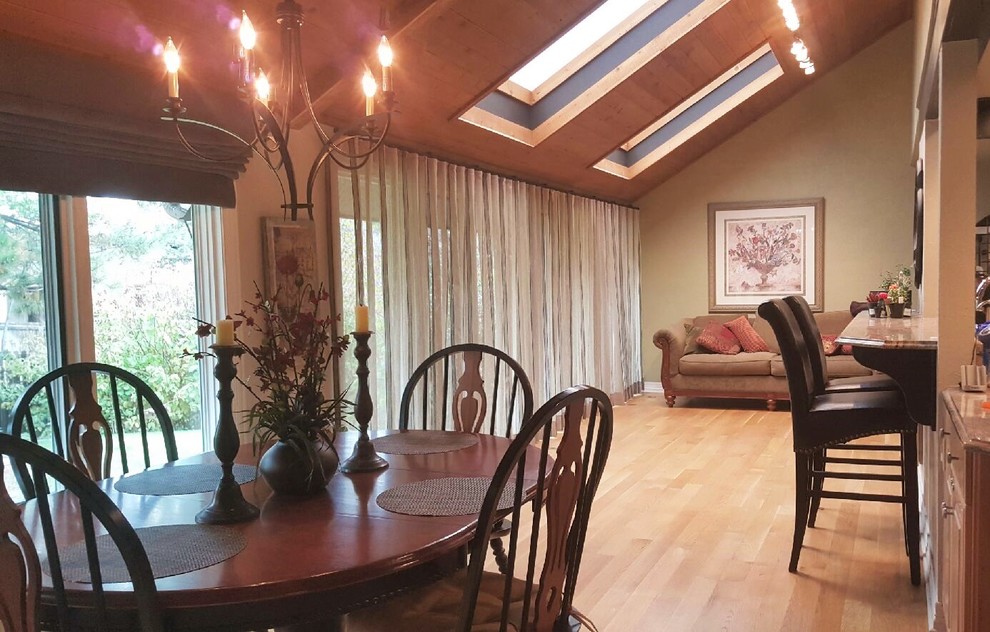 This is an example of an expansive eclectic open plan dining room in Denver with grey walls and medium hardwood flooring.