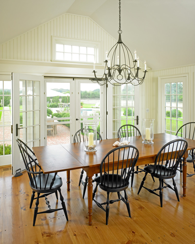 Photo of a large farmhouse open plan dining room in Boston with white walls and medium hardwood flooring.