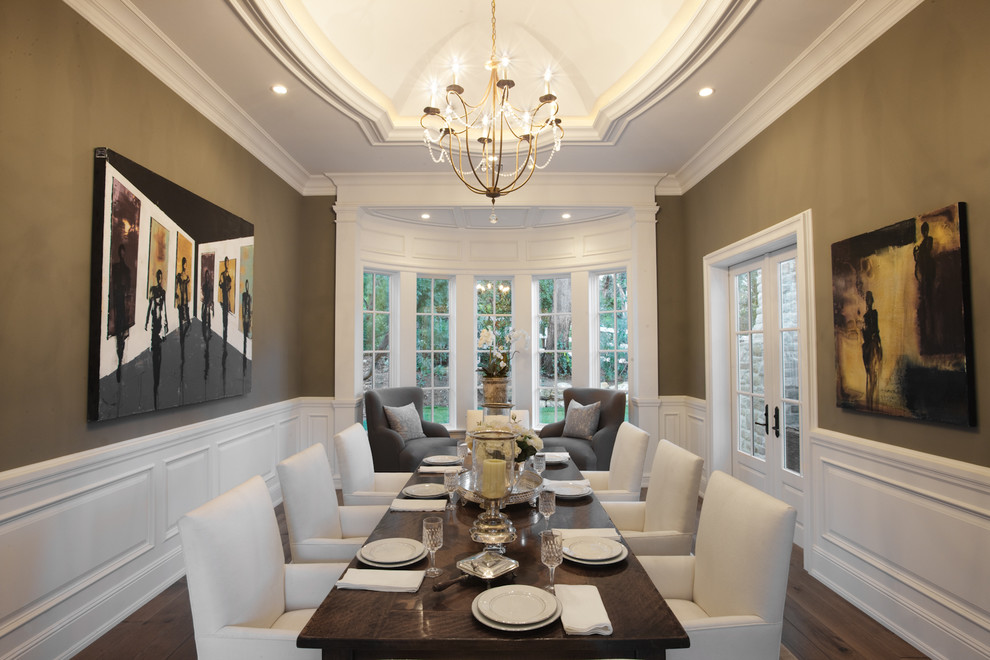 Example of a classic dark wood floor enclosed dining room design in Los Angeles with brown walls