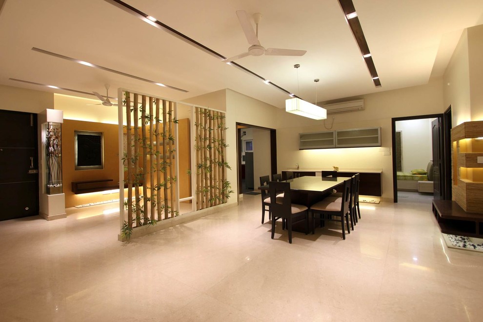 Inspiration for a contemporary dining room in Hyderabad with feature lighting.