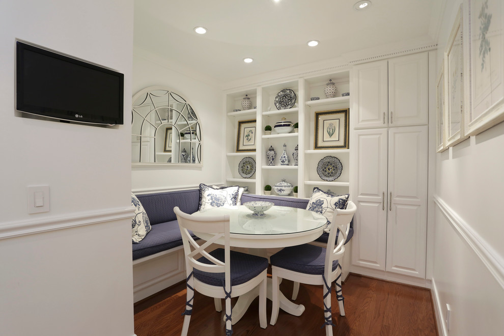 Photo of a traditional dining room in Houston with white walls and dark hardwood flooring.