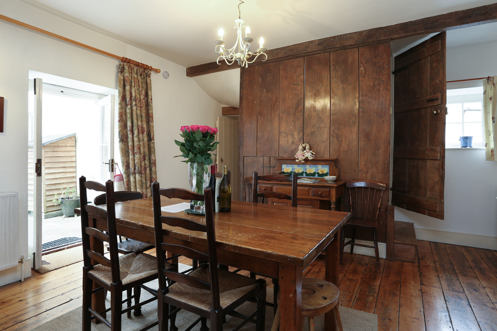 Photo of a medium sized rustic kitchen/dining room in London with brown floors, white walls and medium hardwood flooring.