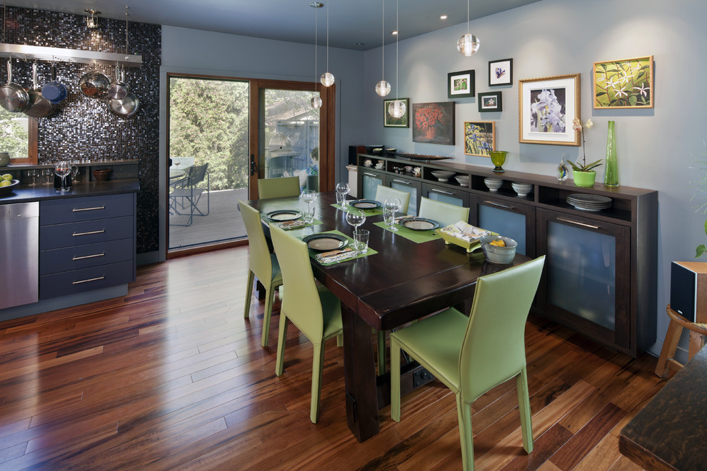 Idée de décoration pour une salle à manger ouverte sur la cuisine bohème avec un mur gris et parquet foncé.