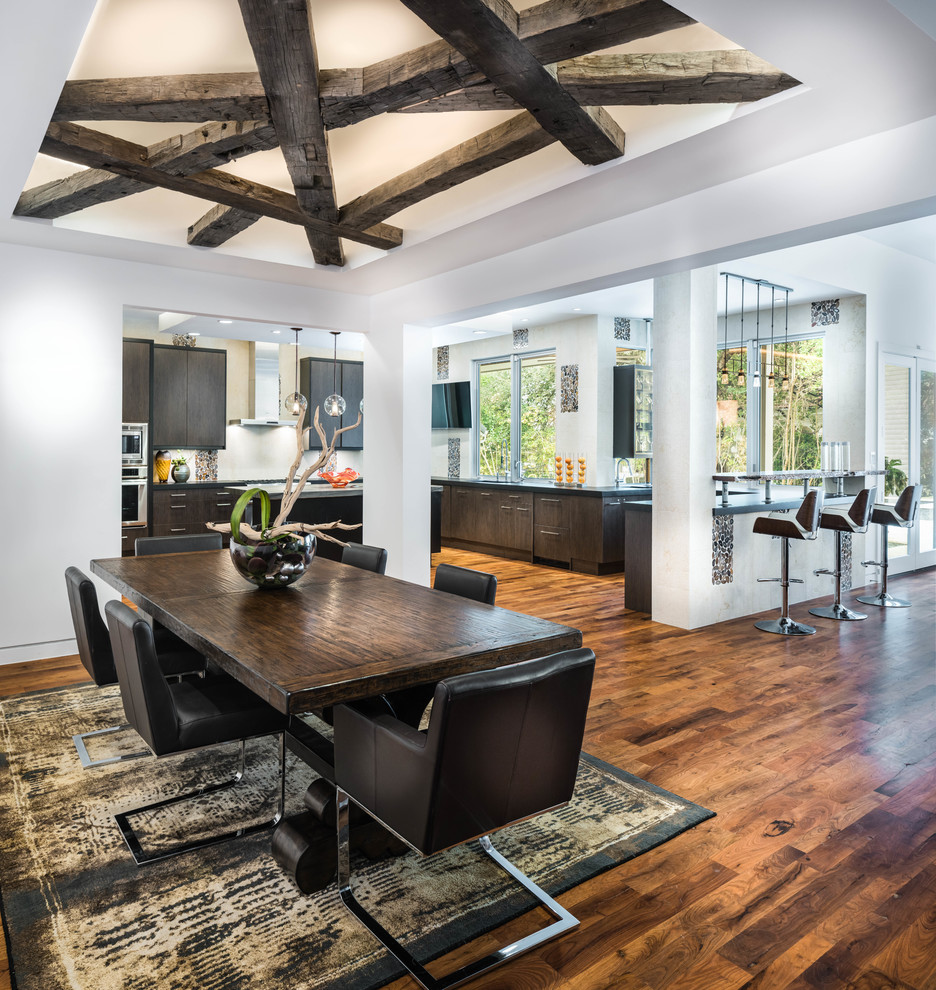 Contemporary open plan dining room in Austin with white walls and medium hardwood flooring.