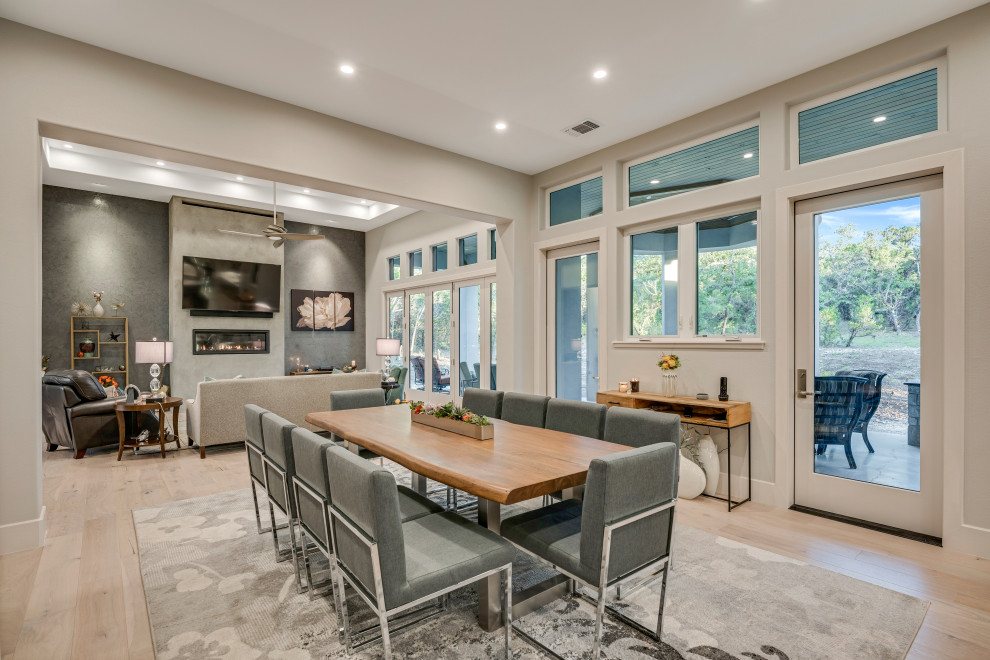Inspiration for a contemporary dining room in Austin with grey walls, light hardwood flooring and beige floors.