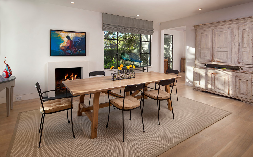 Inspiration for a mid-sized modern light wood floor kitchen/dining room combo remodel in Santa Barbara with white walls, a standard fireplace and a plaster fireplace