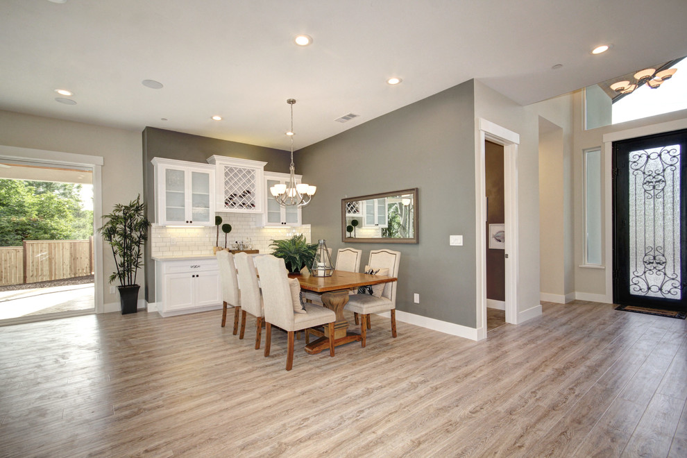 Inspiration for a mid-sized timeless laminate floor and gray floor great room remodel in Sacramento with gray walls, a standard fireplace and a plaster fireplace