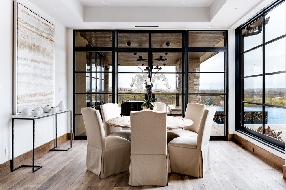 This is an example of an expansive classic dining room in Dallas.