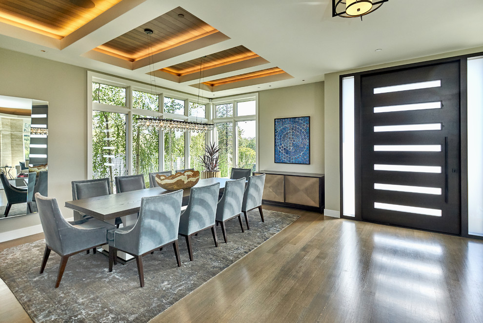 Photo of a large contemporary open plan dining room in San Francisco with beige walls, dark hardwood flooring, brown floors and feature lighting.