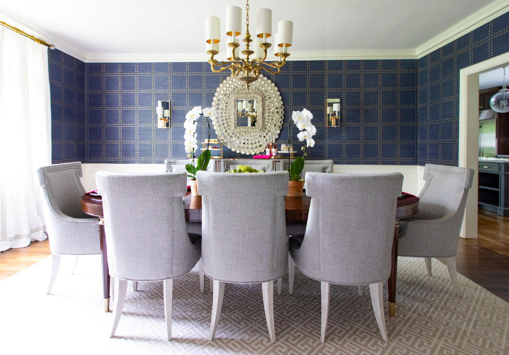 Classic dining room in New York with blue walls, dark hardwood flooring and brown floors.