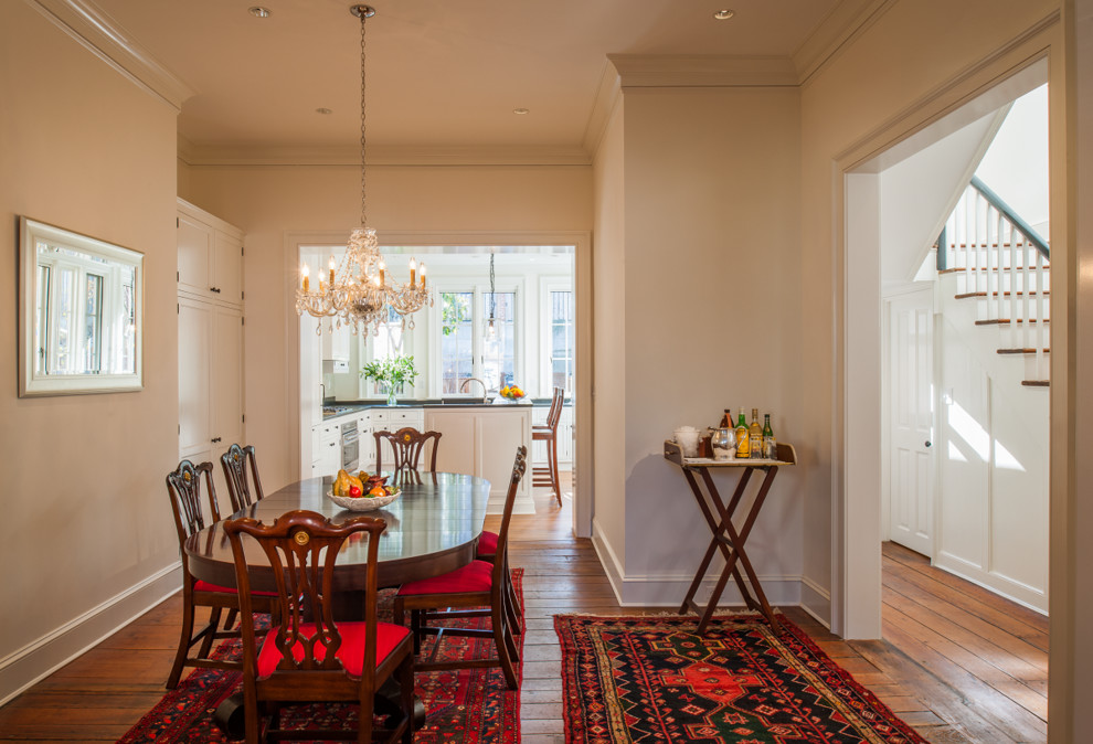 Mid-sized elegant medium tone wood floor and brown floor kitchen/dining room combo photo in DC Metro with white walls and no fireplace