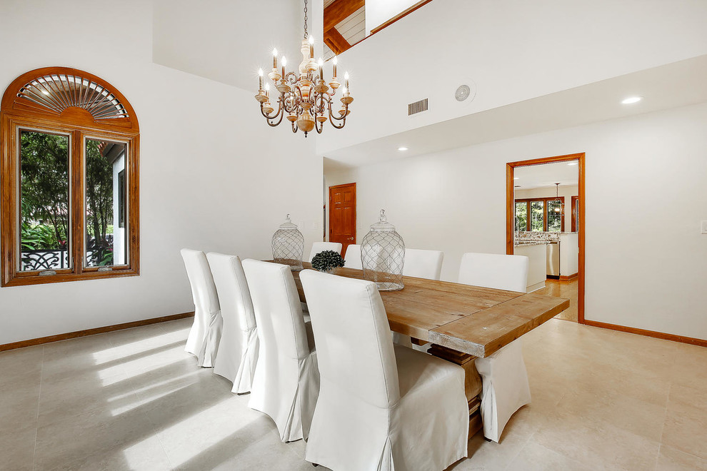 Design ideas for a mediterranean dining room in Miami with white walls.