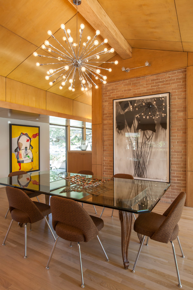This is an example of a midcentury dining room in Dallas with light hardwood flooring and no fireplace.