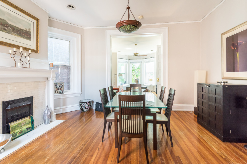 Medium sized traditional enclosed dining room in Wilmington with beige walls, medium hardwood flooring, a standard fireplace and a tiled fireplace surround.