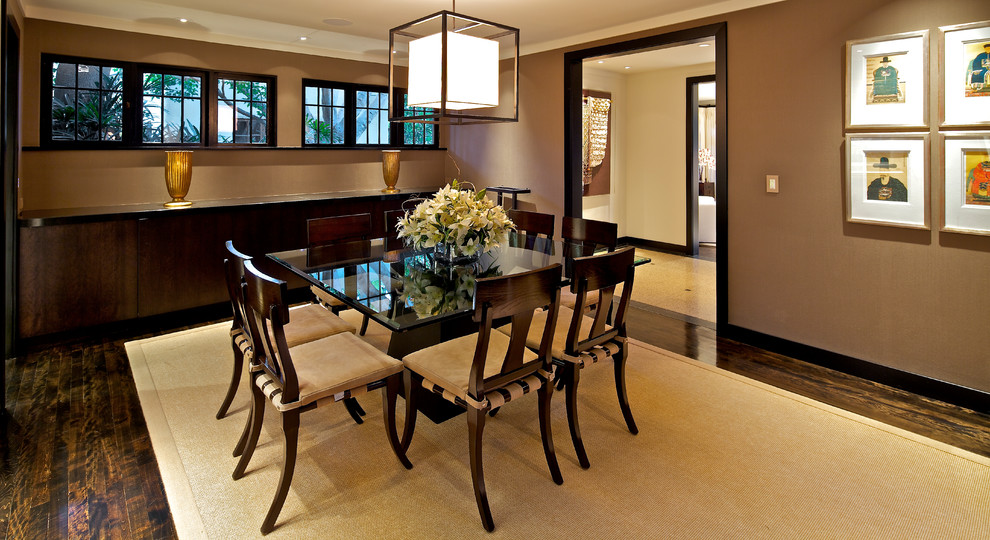 Example of a large eclectic dark wood floor enclosed dining room design in San Diego with brown walls and no fireplace