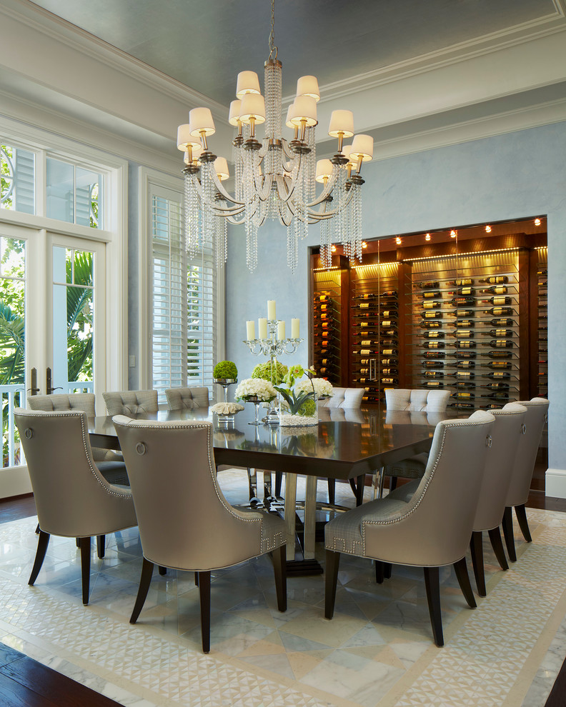 Photo of an expansive beach style enclosed dining room in Miami with blue walls and dark hardwood flooring.
