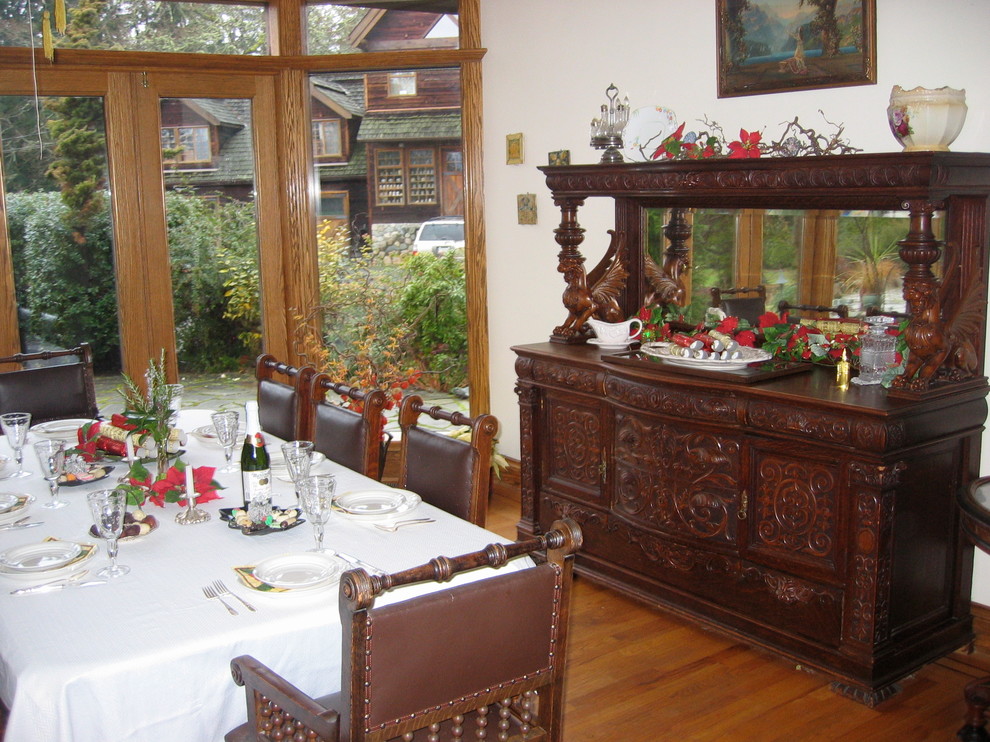 Esempio di una grande sala da pranzo aperta verso il soggiorno vittoriana con pareti bianche, pavimento in legno massello medio e pavimento marrone