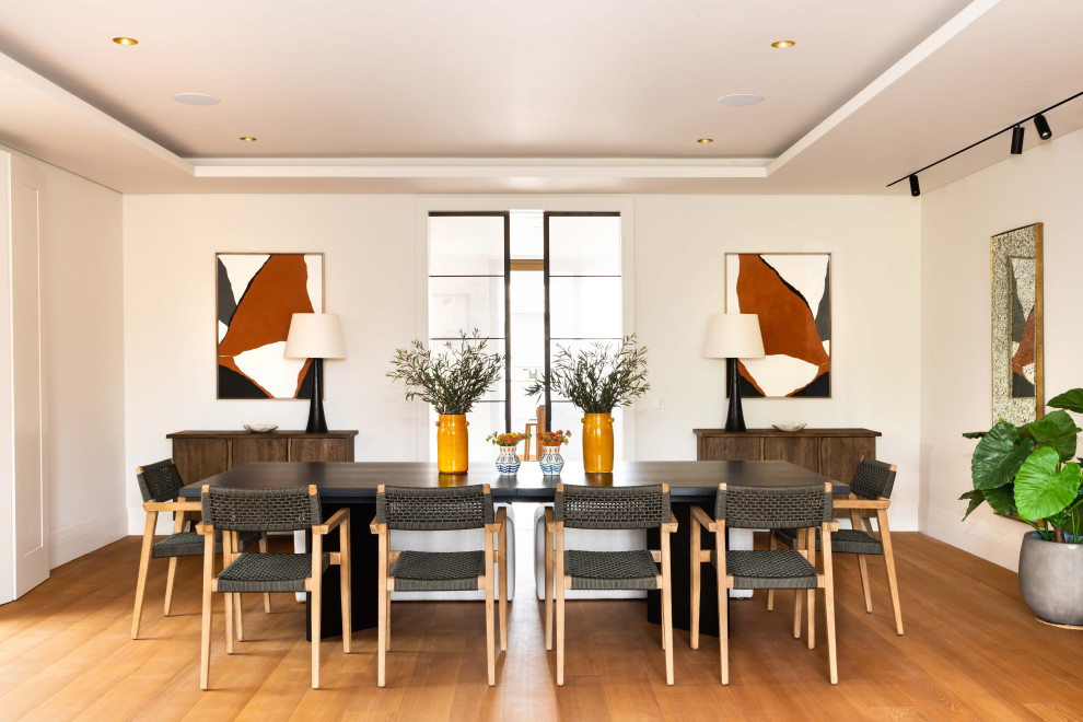 Inspiration for a contemporary medium tone wood floor, brown floor and tray ceiling dining room remodel in London with white walls