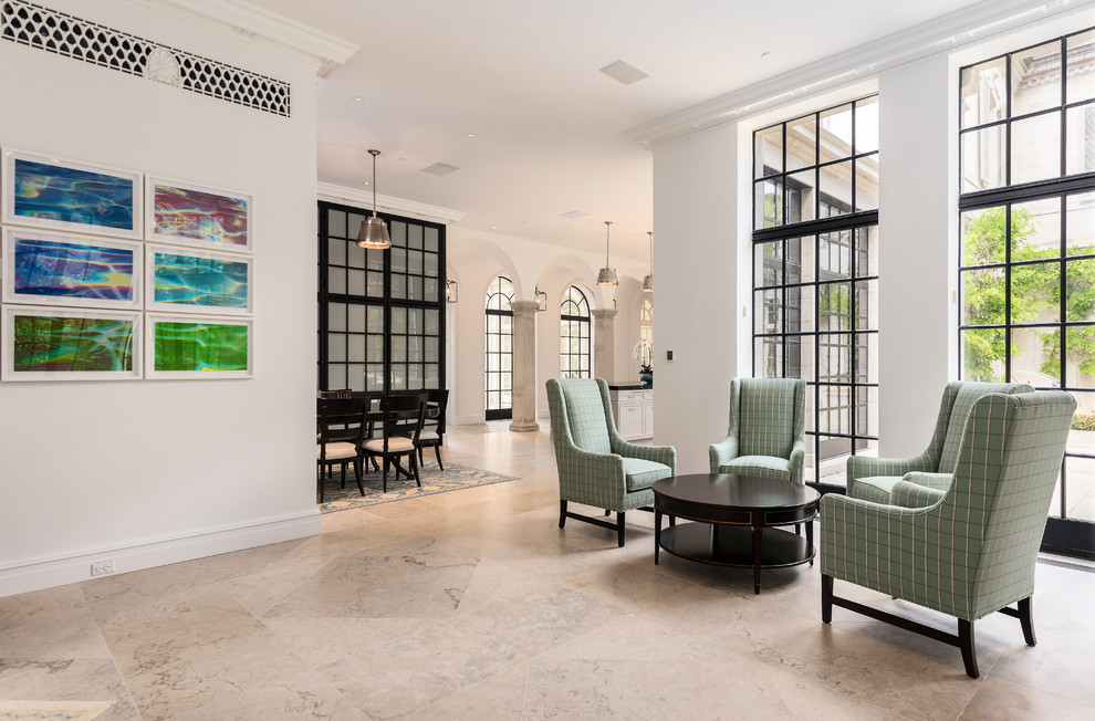 Huge elegant limestone floor and beige floor kitchen/dining room combo photo in Dallas with white walls, a corner fireplace and a stone fireplace