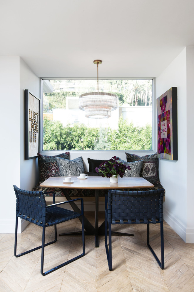 Inspiration for a small contemporary dining room in Los Angeles with light hardwood flooring and white walls.