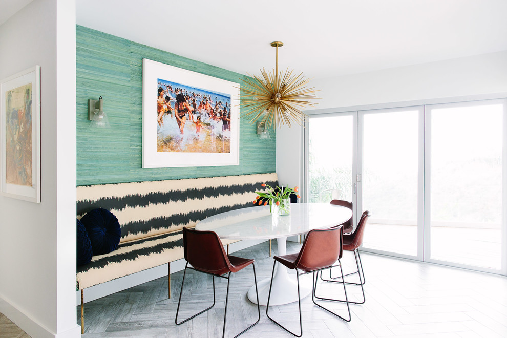 Photo of a contemporary dining room in Los Angeles with green walls and light hardwood flooring.