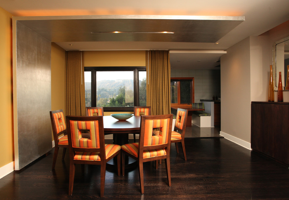 This is an example of a medium sized contemporary kitchen/dining room in Los Angeles with green walls, dark hardwood flooring and brown floors.