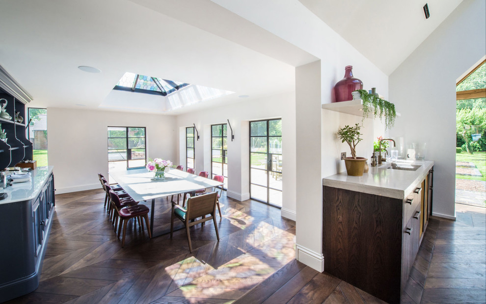 Large urban open plan dining room in Other with white walls, dark hardwood flooring, no fireplace and brown floors.