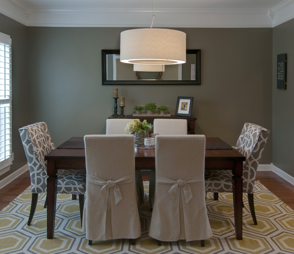 Immagine di una sala da pranzo minimalista di medie dimensioni e chiusa con pareti verdi e pavimento in legno massello medio