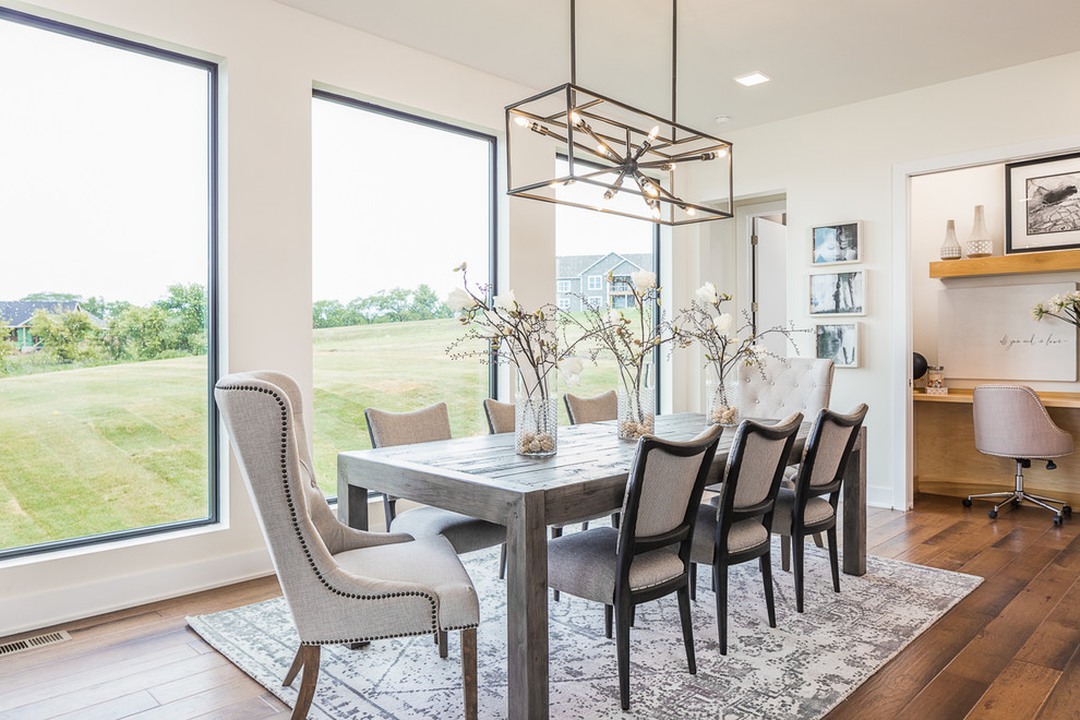 Mid-sized transitional medium tone wood floor and brown floor kitchen/dining room combo photo in Other with white walls and no fireplace