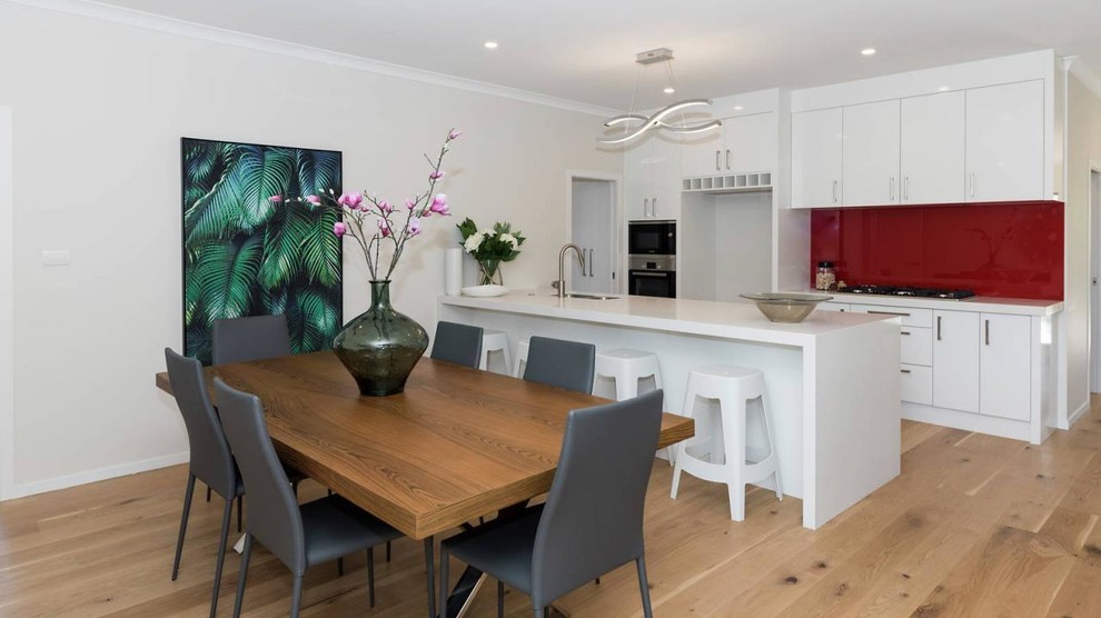 Photo of a small contemporary kitchen/dining room in Auckland with light hardwood flooring and no fireplace.