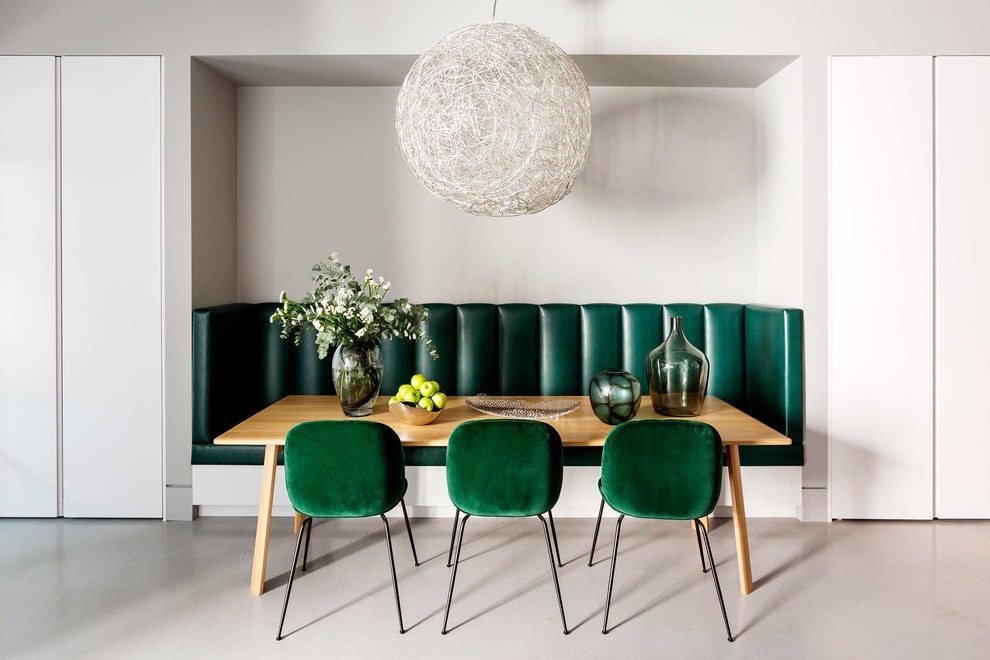 Cette image montre une salle à manger minimaliste de taille moyenne avec un mur gris et un sol gris.